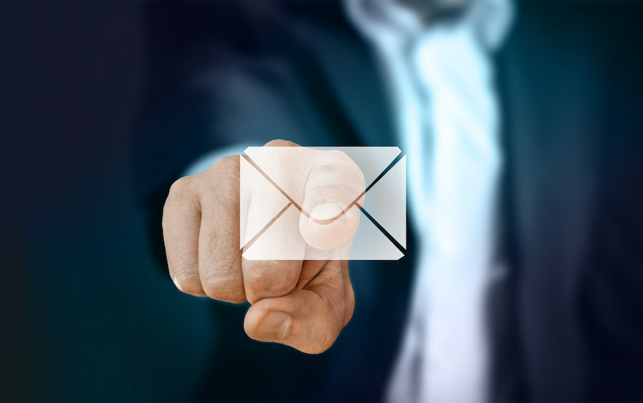 businessman pressing an email icon