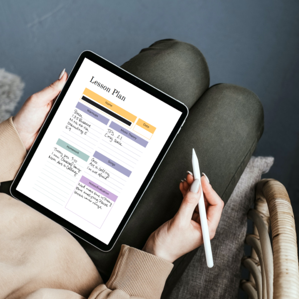 woman filling out vocal music lesson plans on her ipad