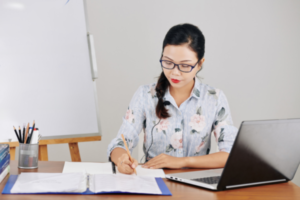 a woman sitting down to create a music lesson plan