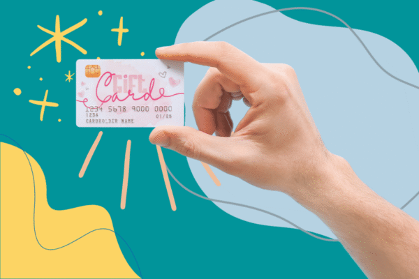 a hand holding a gift card over a colorful background